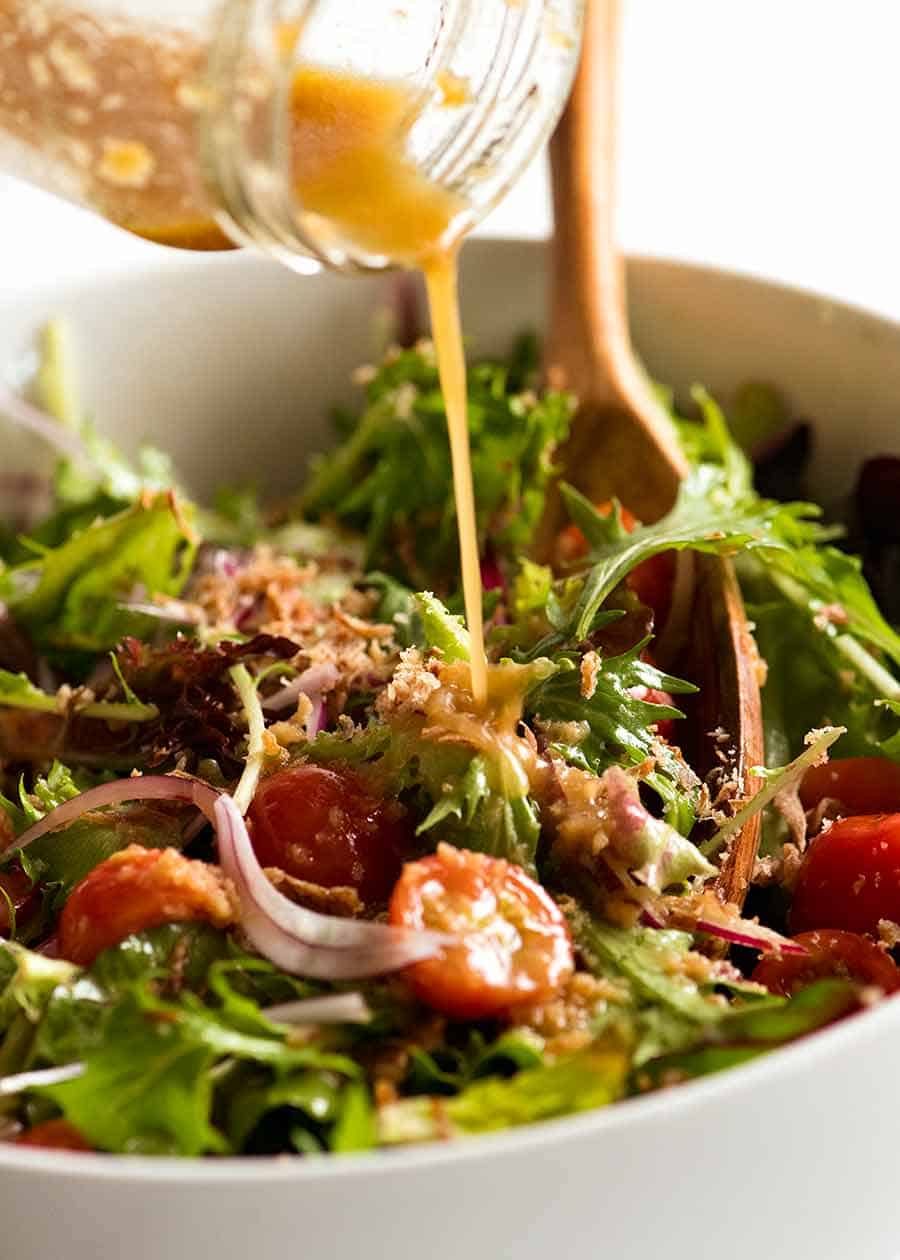 Asian Dressing for Asian Side Salad being drizzled over salad