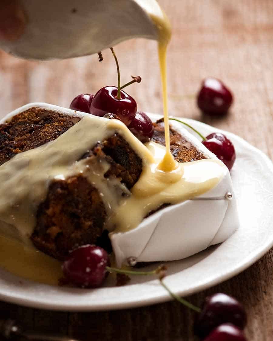 Pouring custard over Christmas Cake